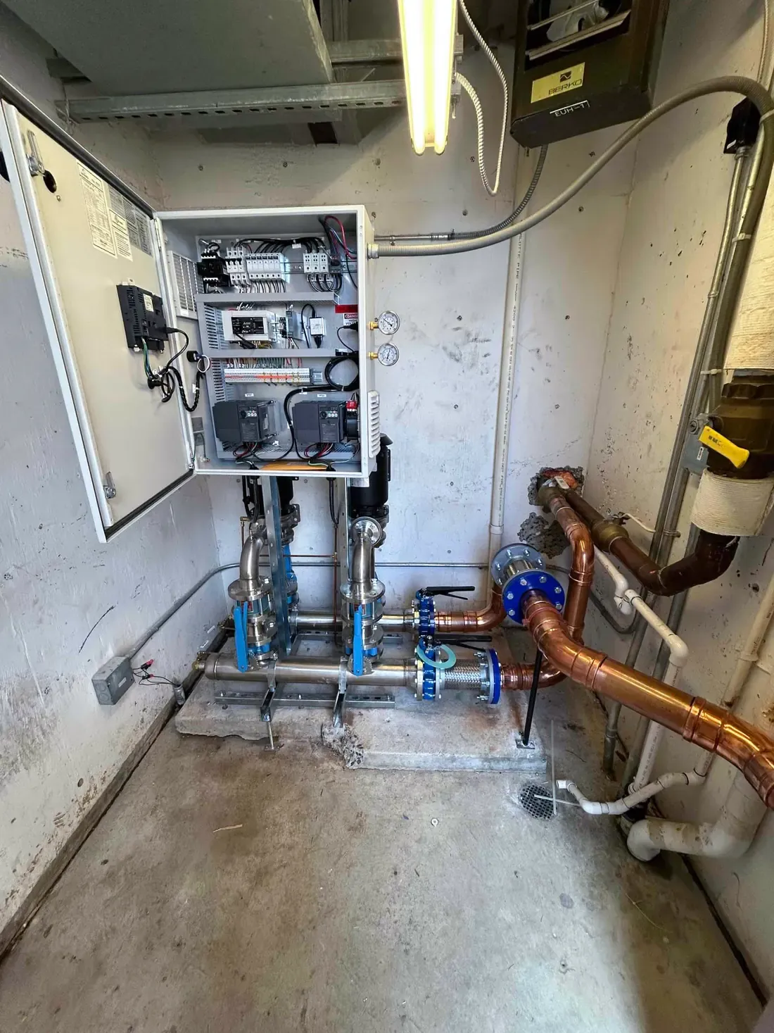 Replacement booster system with new control panel, valves and copper piping after installation