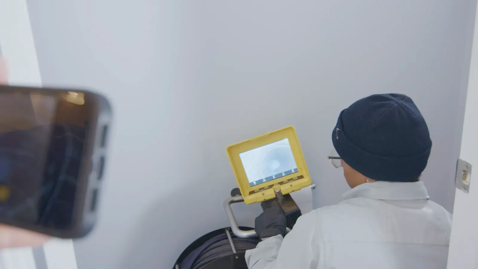 CJ from Mallick Plumbing & Heating operating a sewer inspection camera