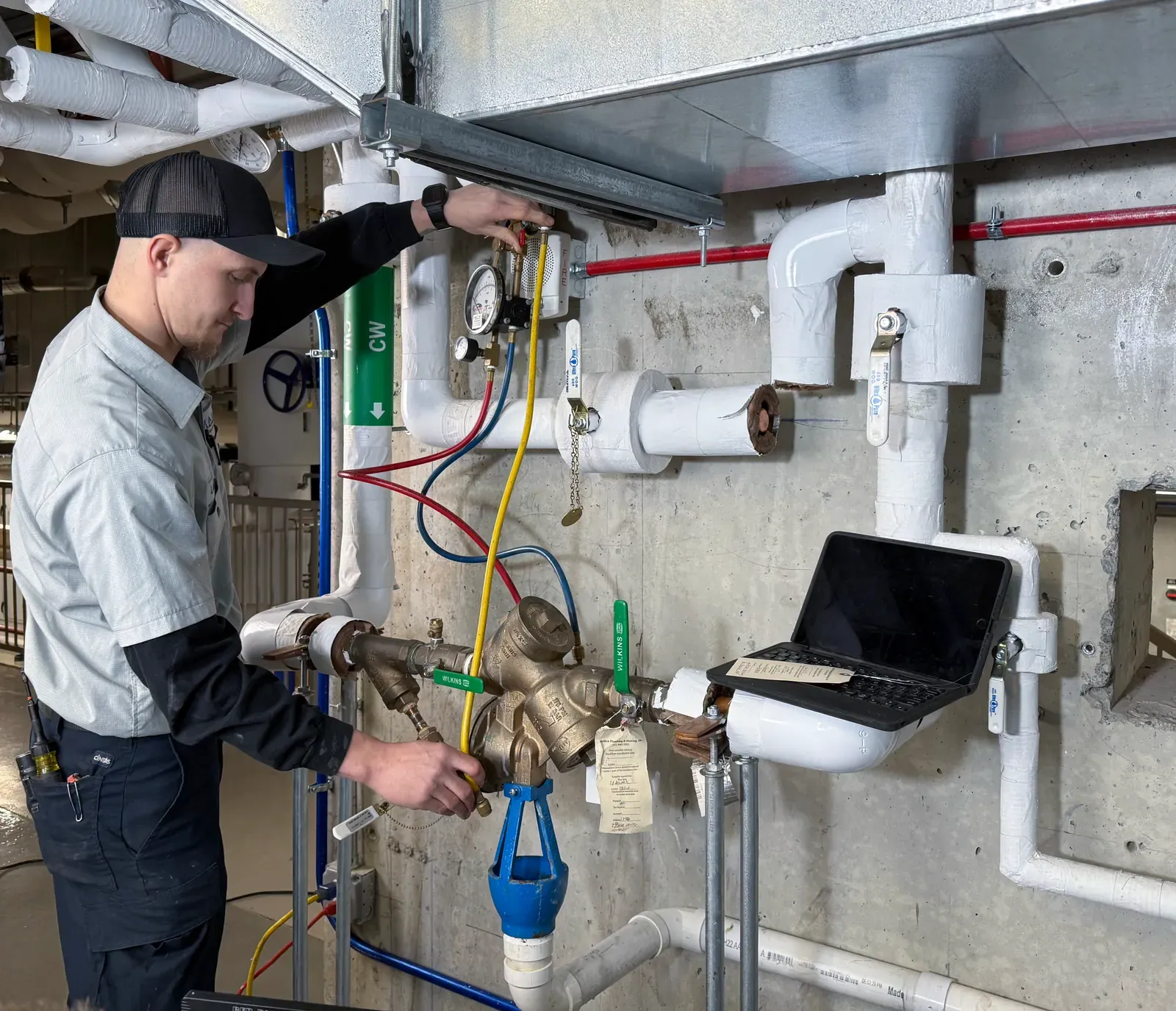 Lance from Mallick Plumbing & Heating testing a commercial backflow preventer