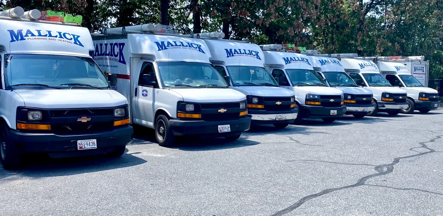Mallick Plumbing & Heating service trucks lined up for work