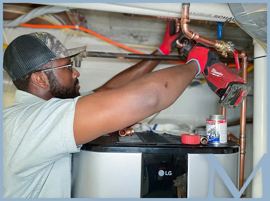 Mallick plumbing technician working on water-heater piping