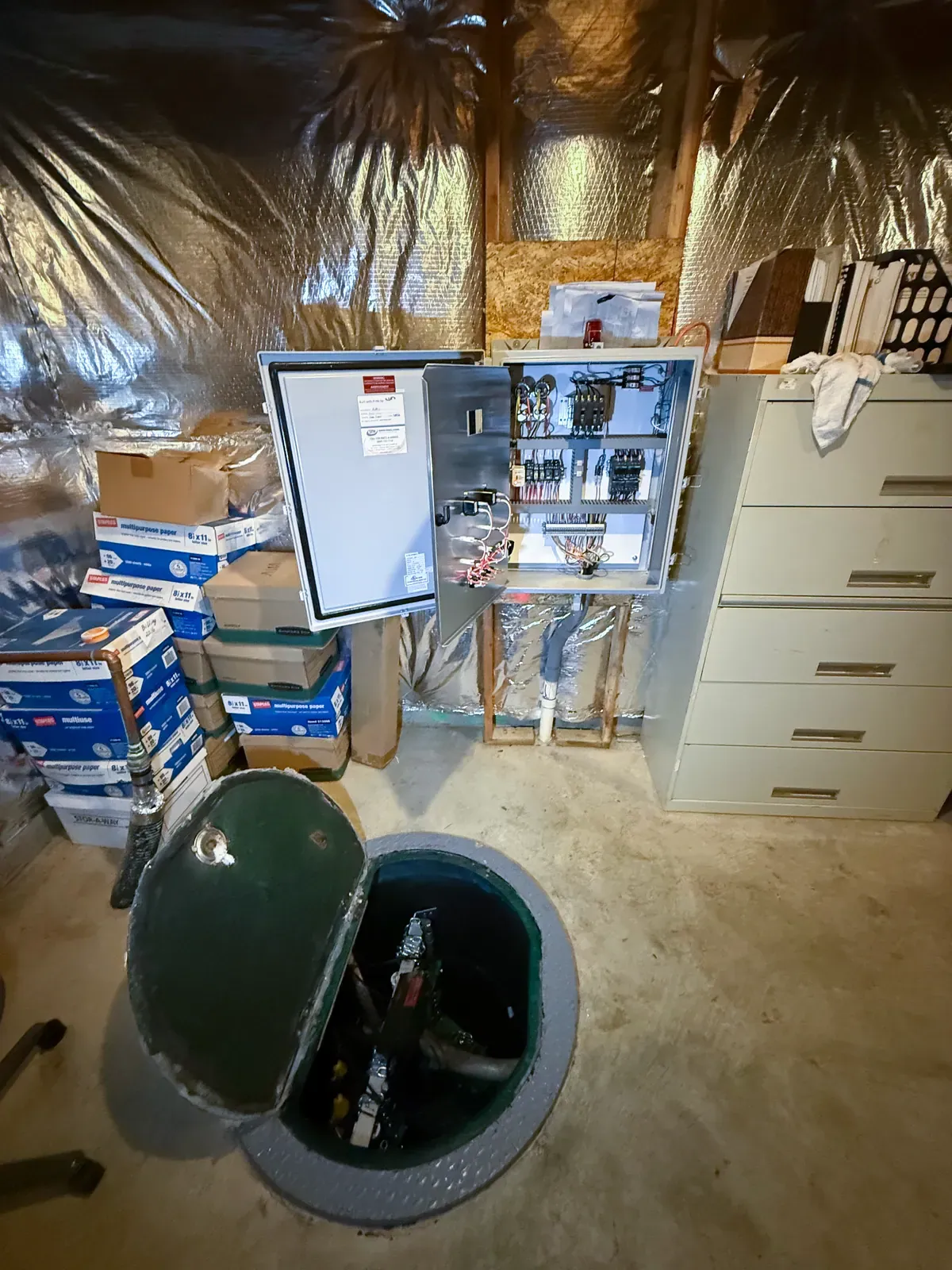 Mallick Plumbing & Heating sewage pump replacement with the basin and control panel exposed