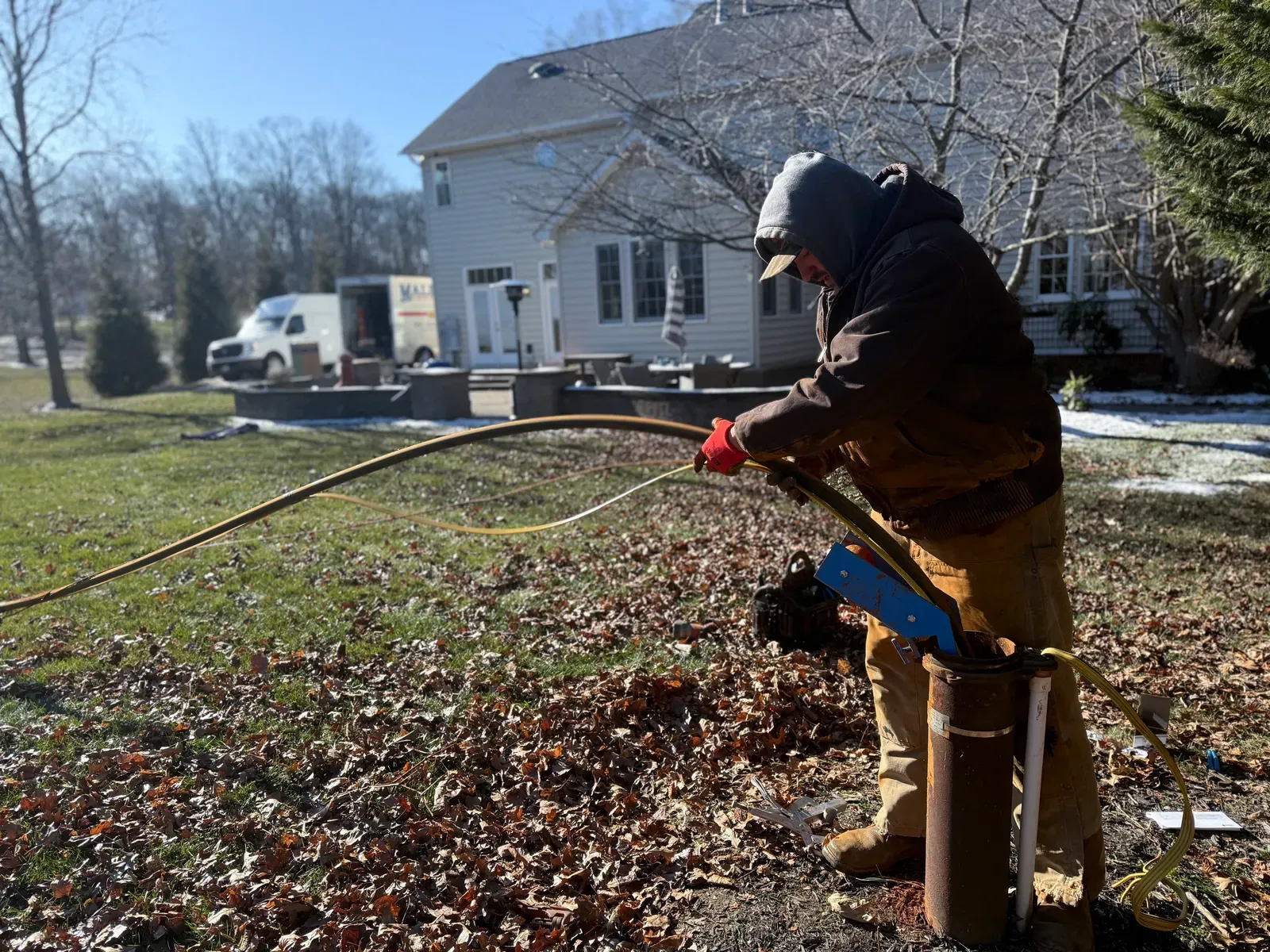 Mallick technician replacing a well pump outside a Maryland home