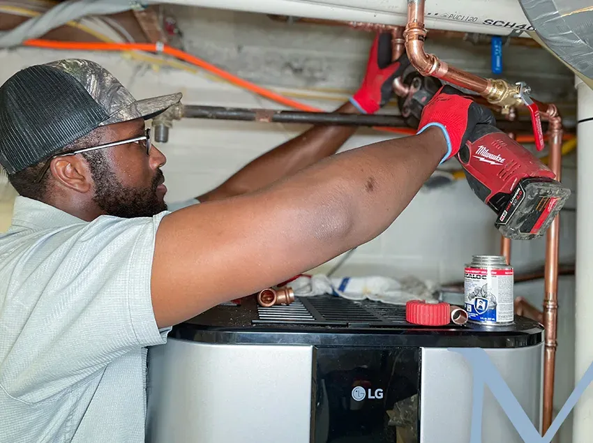 Mallick technician repairing copper supply lines in a Maryland home